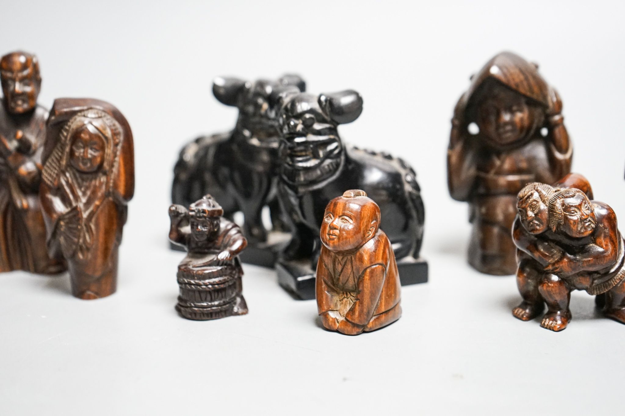 A quantity of hardwood netsuke and other carvings, signed